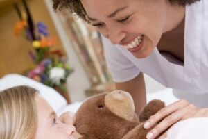 Nurse Laughing With Her Young Patient